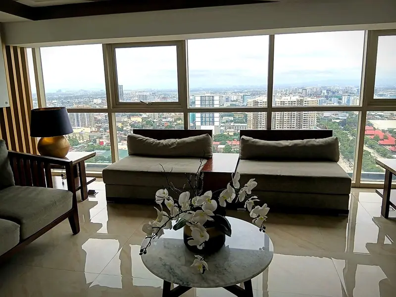Sofas by the floor-to-ceiling windows of the sky lounge