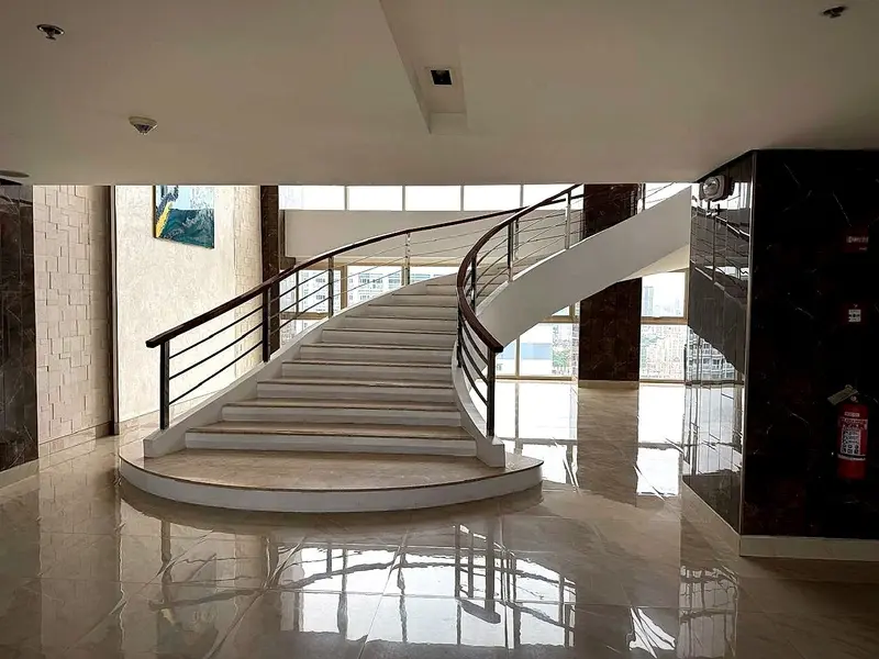A curved marble staircase in the lobby